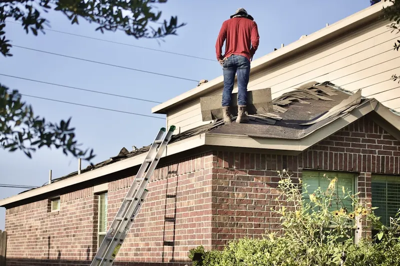 Professional roofer working on a residential roof in Oakwood Estates